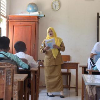 Foto: Seorang guru sedang mengajar di kelas. Sumber: Istimewa.
